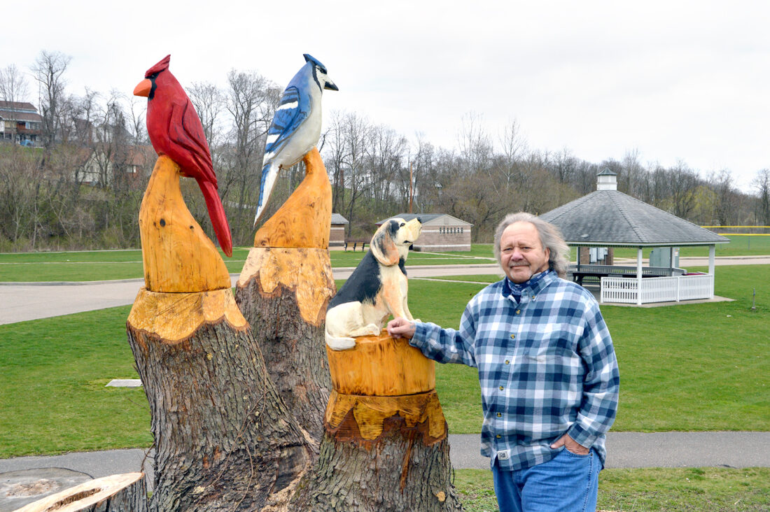Wood-carved statues charming Jim Woods Park visitors in